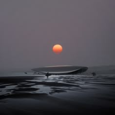 the sun is setting over an ocean with people walking on it and a boat in the water