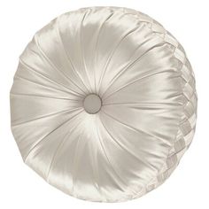 a white round pillow sitting on top of a table