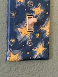 a blue and yellow light switch cover with stars on it