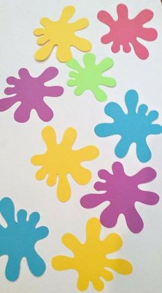 several different colored hand prints on a white surface