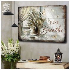 a wooden sign that says just breathe with flowers in a vase on the table next to it