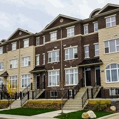 a row of brick townhouses on a cloudy day