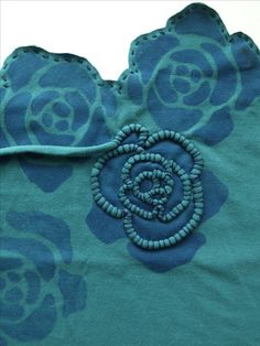 a close up of a blue shirt with flowers on it