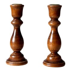 two wooden candlesticks sitting next to each other