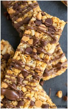 chocolate and peanut butter granola bars are stacked on top of each other with one bite taken out