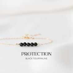 "Delicate protection bracelet - handmade with Black Tourmaline 4mm Crystal Beads on a 14k Gold-Filled or 925 Sterling Silver chain. Our black tourmaline bracelet is your daily source of strength and confidence. It serves as a potent shield against negativity, ensuring you move through life's emotional energies with unwavering resilience. Wear it every day and feel empowered, knowing you have a steadfast companion to boost your confidence, provide strength, and offer protection from any negativit Energy Shield, Crystal Protection, Black Tourmaline Bracelet, Silk Bracelet, Black Tourmaline Crystal, Tourmaline Bracelet, Protection Bracelet, Tourmaline Crystal, Boost Your Confidence