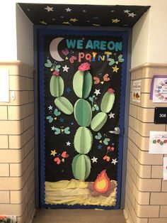 a door decorated with a cactus and stars in the night sky, which reads we are painted