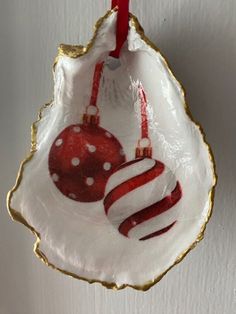 two red and white ornaments hanging from a wall