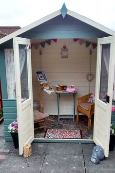 a small shed with two chairs and a table in it