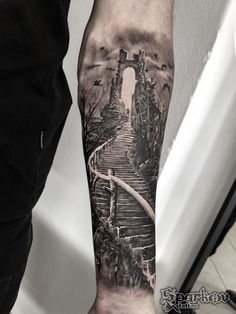 a man with a black and white tattoo on his arm that has stairs going up to the sky