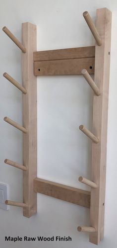 a wooden shelf with several pegs attached to it