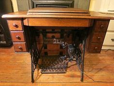 an old sewing machine sitting on top of a wooden table