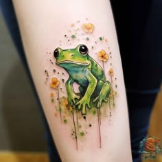 a green frog sitting on the side of a woman's leg with flowers around it