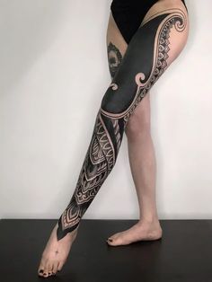 a woman's leg with tattoos on it