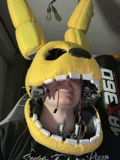 a person wearing a yellow bunny mask with wires attached to it's ears and eyes