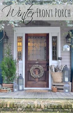 the front door of a house with wreaths and lanterns on it's porch