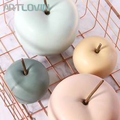 three different colored donuts sitting on a wire rack