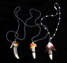 three necklaces with beads and feathers on them