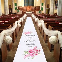 a wedding aisle decorated with flowers and ribbons