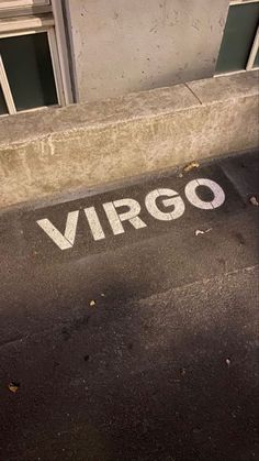 a street sign that reads virgo next to a building