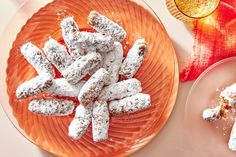 two plates filled with powdered sugar cookies