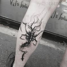 a man's leg with a spider tattoo on it