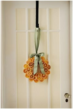 an orange and green wreath hangs on the front door