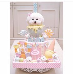 a teddy bear sitting on top of a cake