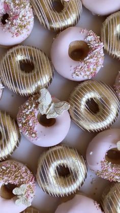 there are many donuts with pink frosting and sprinkles