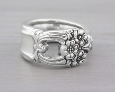 a silver ring with flowers on it