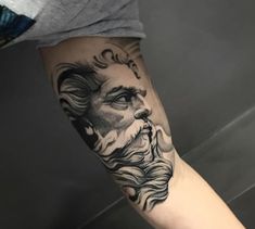 a man's arm with a tattoo on it that has an image of jesus