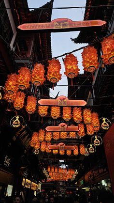 many orange lanterns hanging from the ceiling