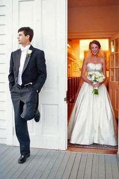 a bride and groom standing in front of the door