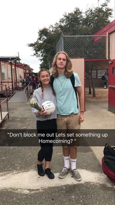 two people standing next to each other in front of a building with a sign that says, don't block me out lets set something up