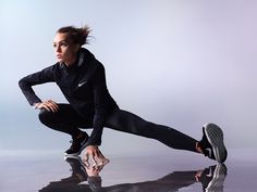 a woman in black running clothes and sneakers