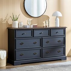 a black dresser and mirror in a room