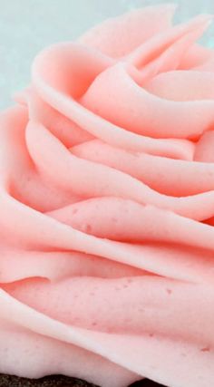 pink frosted cupcake with white icing and sprinkles