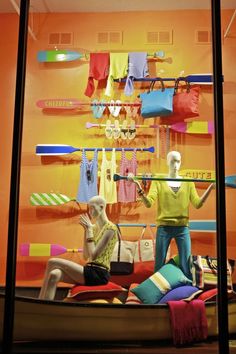 two mannequins are sitting in front of a window display