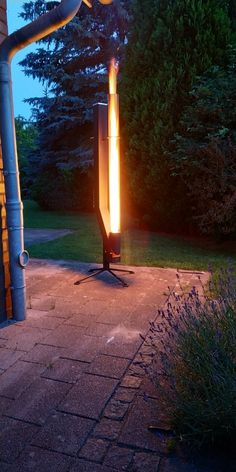 an outdoor fire pit is lit up at night