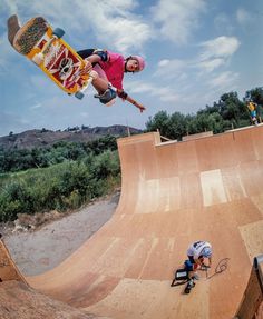 a man on a skateboard is doing tricks in the air at a skate park