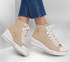 Lace into a lifted classic wearing Skechers Street Happi - Elevated Steps. This vegan high-top fashion sneaker features a laced canvas upper with a synthetic toe cap, wedge midsole, and a Skechers Air-Cooled Memory Foam insole. | Skechers Women's Happi - Elevated Steps Sneaker | Medium Width | Skechers Air-Cooled Memory Foam cushioned comfort insole | Crafted with 100% vegan materials | Lace-up canvas upper and rubber toe cap | High-top fashion wedge sneaker | Flexible traction outsole | 2 1/2-i Wedges Style, Skechers Women, Skechers Shoes, Wedge Sneaker, Wedge Heels, Womens Shoes Sneakers, High Top, Sneakers Fashion, High Tops