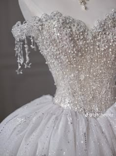 a white ball gown with beading on it