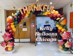 balloons are arranged in the shape of an arch for a thank you balloon display at a school