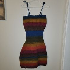 a multicolored dress hanging on a white wall