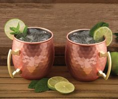 two copper mugs with lime and mint garnish