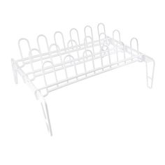 a white rack that is holding several pairs of scissors