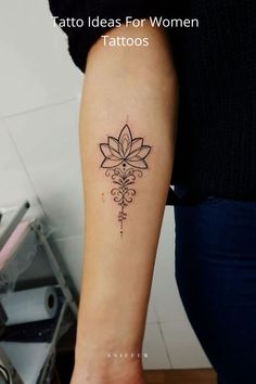 a woman's arm with a tattoo on it and a flower in the middle