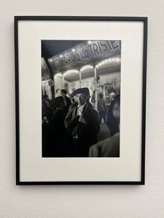 a black and white photo hanging on the wall