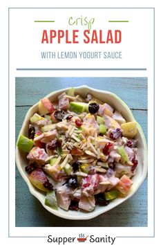 an apple salad with lemon yogurt sauce in a bowl on top of a table