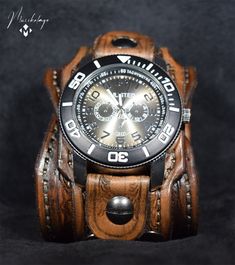 "Maverick Leather Cuff Watch, men's handmade leather cuff watch with 2.5 inches width is dyed in antique medium and dark brown. The leather cuff has a snap button closure and two settings fit for small and medium-sized wrists, made of American vegetable-tanned leather and polished and finished with the waxed top coat to give it a vintage look. Item includes watch face and is removable and interchangeable. Upon request can be made to your size in a different color of your choice. Completely handm Leather Watches For Men, Brown Band Watch, Brown Watch, Brown Watches, Cuff Watch, Wrist Band, Leather Cuffs, Watch Faces, Vegetable Tanned Leather